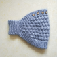 Strickstirnband für Damen mit Blumenakzenten